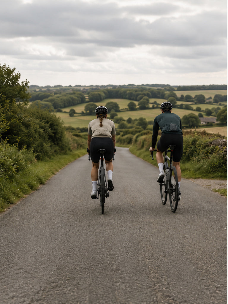 Two cyclists riding on a quiet UK country road